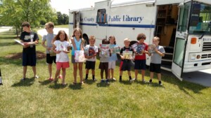 Readers with books checked out from bookmobile